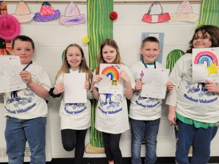 Students showing off coloring worksheet